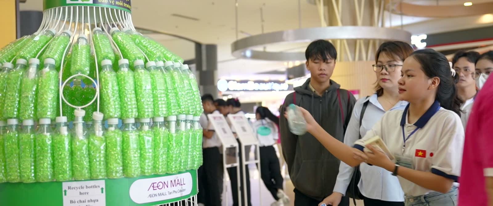 Nhân viên AEON đứng cùng nhau trong không gian trung tâm mua sắm.